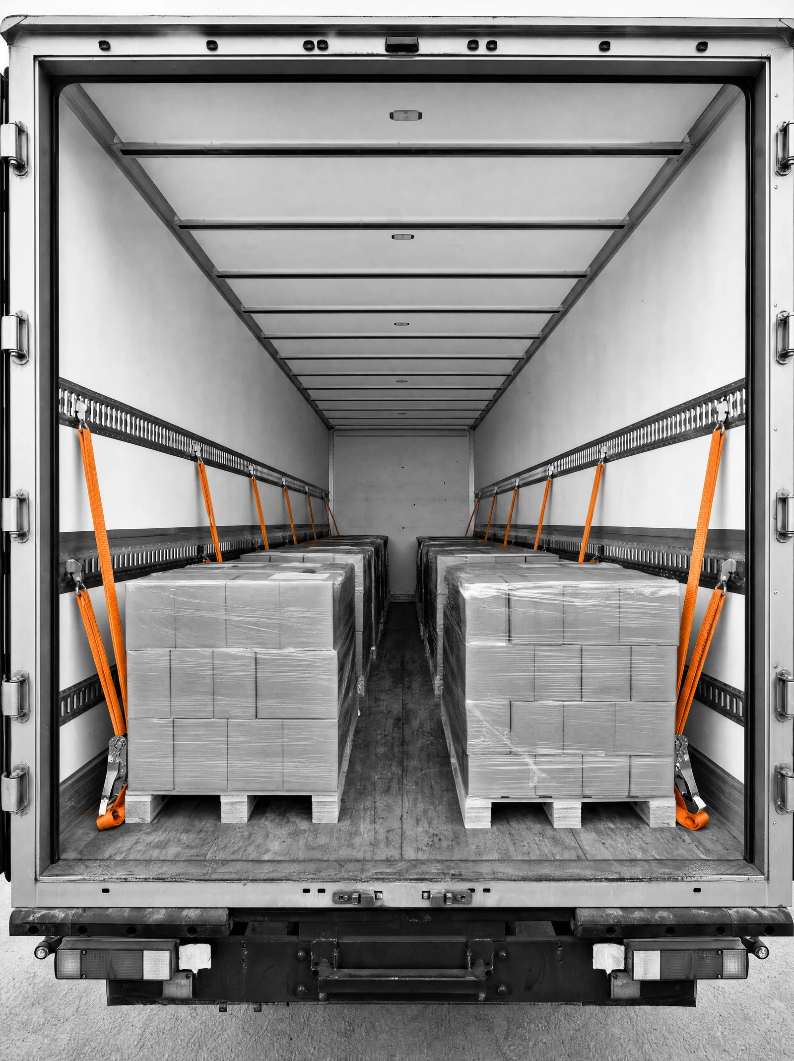 Shrink-wrapped LTL pallets strapped inside a DSB trailer